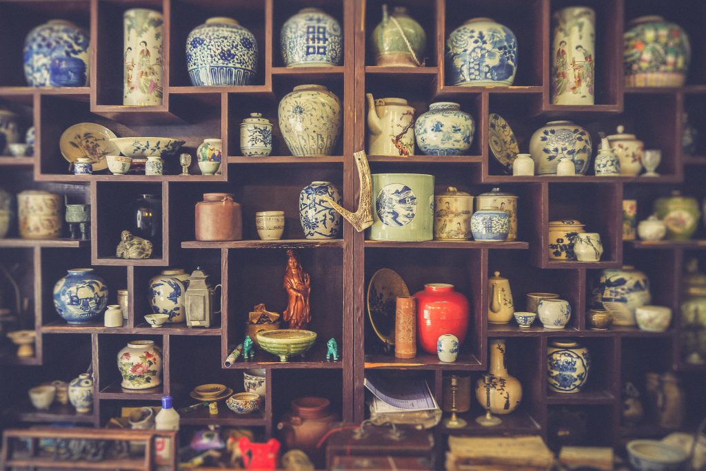 Antique vases and other items displayed on shelves