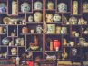 Antique vases and other items displayed on shelves
