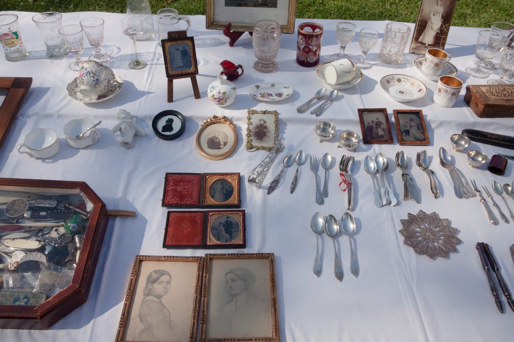 Antique objects arranged on a table at a flea market