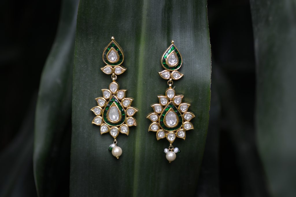 Antique crystal earrings on a leaf