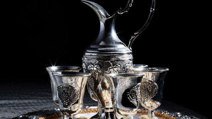 Silver pitcher and goblets on a tray