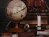 Antique globe and books on a desk.