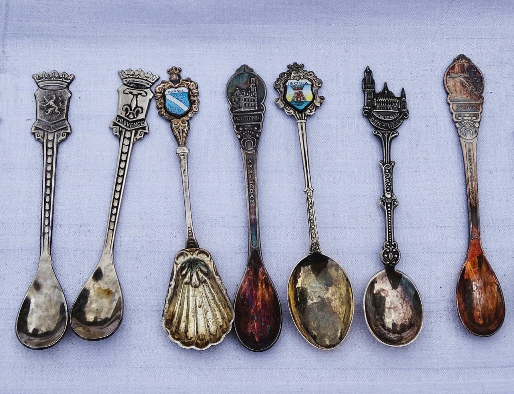 Seven antique silver spoons in a row