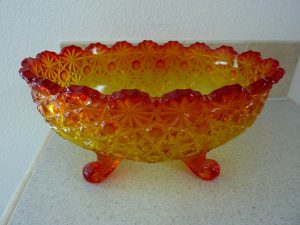 Orange and red hued carnival glass bowl