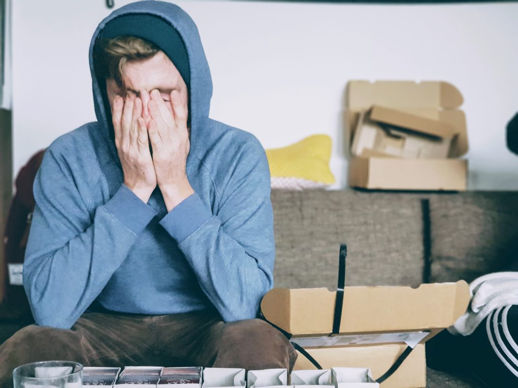 Man covering his face and looking stressed