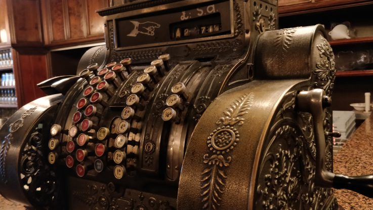 Closeup image of a large bronze vintage cash register