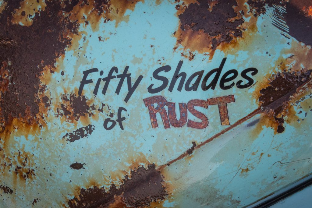 Rusted sign that reads "Fifty Shades of Rust"