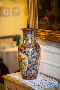 Antique Chinese vase with floral design on a shelf