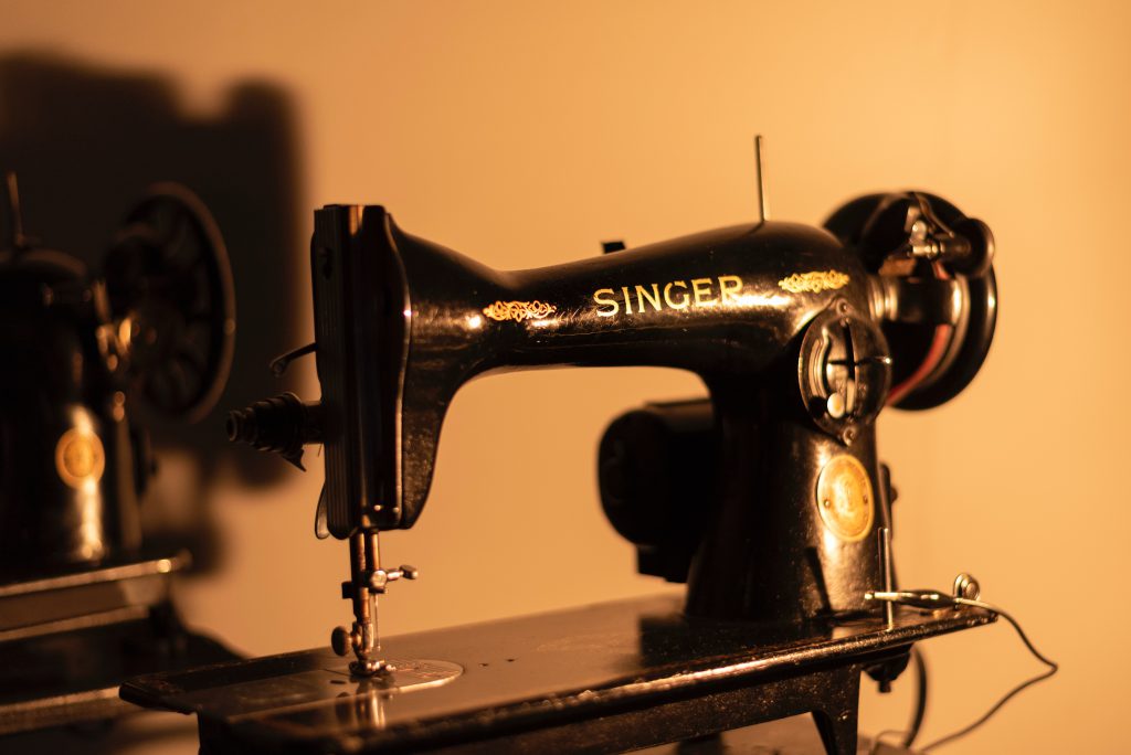 Black singer featherweight 221 sewing machine in low lighting